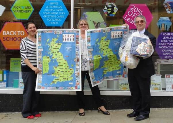 Sabrina Harris and Jan Head of Orchard Print Services with Des Waddington, Project Coordinator for The Church of Jesus Christ of Latter-day Saints holding the Postal Historic Maps of Britain.