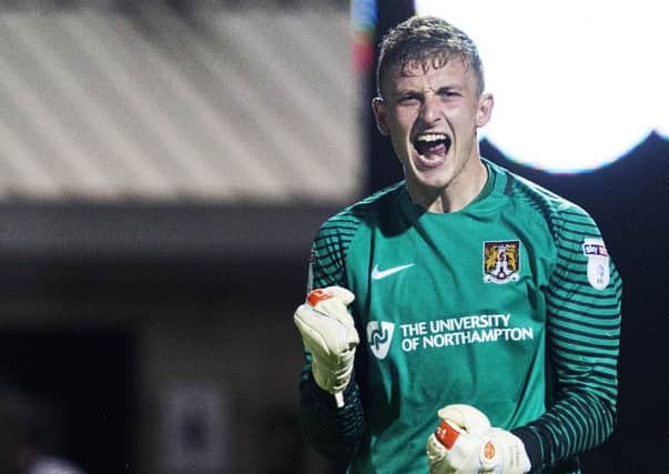 GET IN THERE! - Cobblers goalkeeper Adam Smith celebrates the penalty shootout win over West Brom on Tuesday (Picture: Kirsty Edmonds)