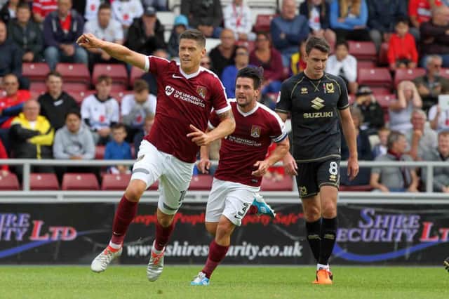 TAKE THAT! - Alex Revell celebrates the Cobblers' second goal aganst Milton Keynes Dons (Pictures: Sharon Lucey)