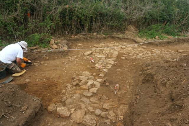 The walls of one of the stone cottages unearthed