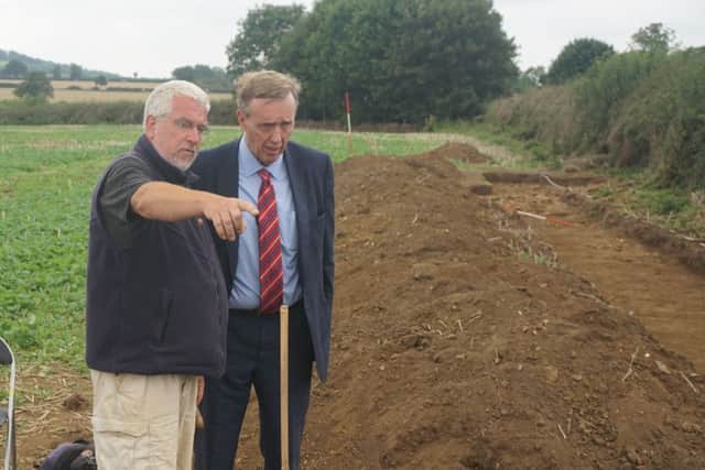 Cllr Chris Millar is shown the excavations
