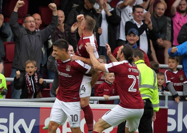 REVELL'S ON FIRE - the Cobblers players celebrate Alex Revell scoring the second in last Saturday's 2-0 win over Walsall