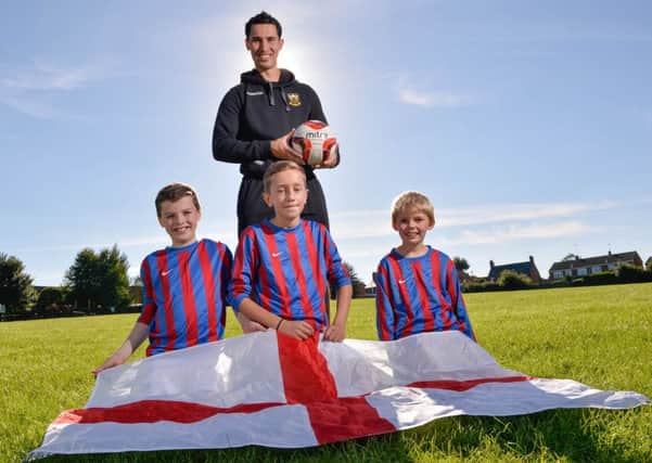 PE teacher Sam Chambers with three of his players (from left: Will, Joe and Ewan). Photo from SWNS.com