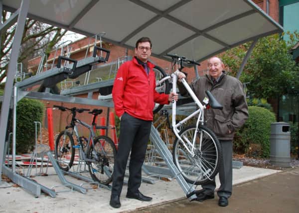 Jamie Brightwell, Everyone Actives general manager at Daventry Leisure Centre, with Councillor Alan Hills at the new bike shelter in Lodge Road.