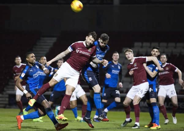 AERIAL BATTLE - Cobblers skipper Marc Richards tries to get on the end of a cross (Pictures: Kirsty Edmonds)
