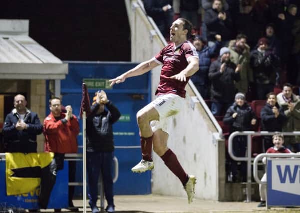 JUMPING FOR JOY - John-Joe O'Toole celebrates his winning goal against Swindon Town (Pictures: Kirsty Edmonds)