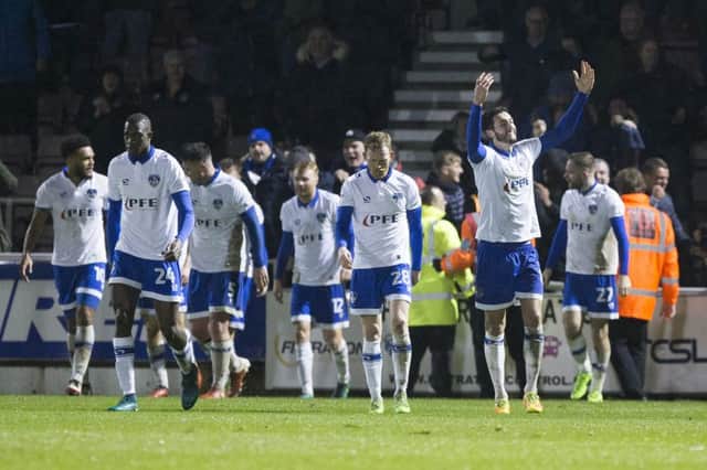 BIG WIN: Oldham celebrate their stoppage-time winner. Pictures: Kirsty Edmonds
