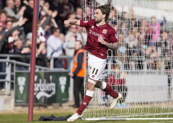 Ricky Holmes celebrates one of his 11 goals for the Cobblers last season
