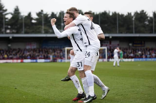YOU BEAUTY! Matty Taylor and team-mates celebrate Saturday's late winner. Pictures: Kirsty Edmonds