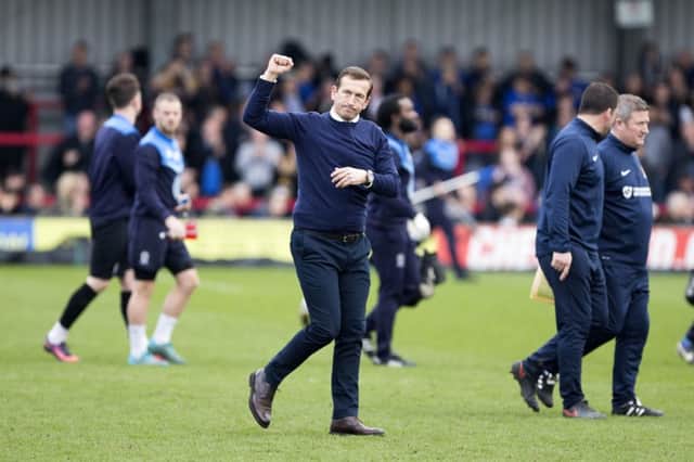 Cobblers boss Justin Edinburgh acknowledges the travelling supporters following Saturday's win at AFC Wimbledon