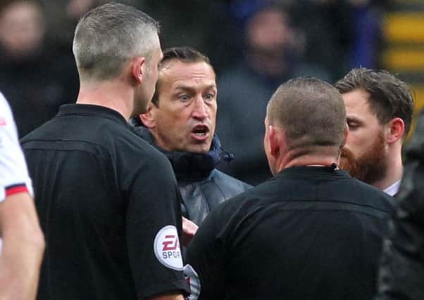 BIG IMPACT - Cobblers boss Justin Edinburgh makes his point to the referee following Saturday's defeat at Bolton Wanderers (Pictures: Sharon Lucey)