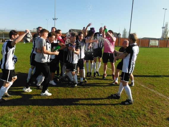 Daventry Town players and staff celebrate after sealing the UCL division one title