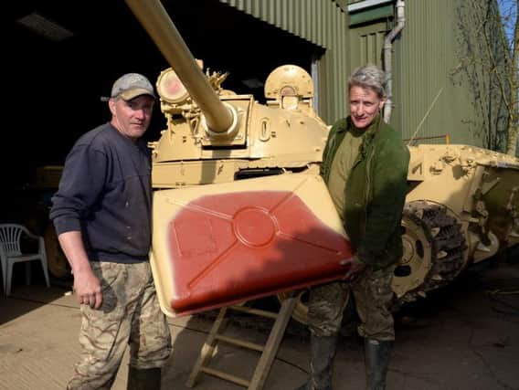 Gold ingots were found in this Iraqi tank at Tanks a Lot, Helmdon. Todd Chamberlain, left and Nick Mead, right, with the auxiliary fuel tank they were found in.