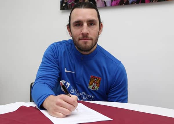 HAPPY MAN - John-Joe O'Toole signs his new Cobblers contract (Picture: Pete Norton)