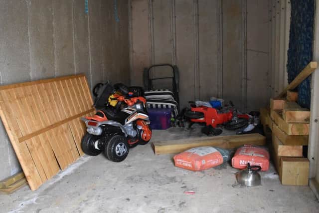 Some children had been playing with a toy tractor inside one of the garages.