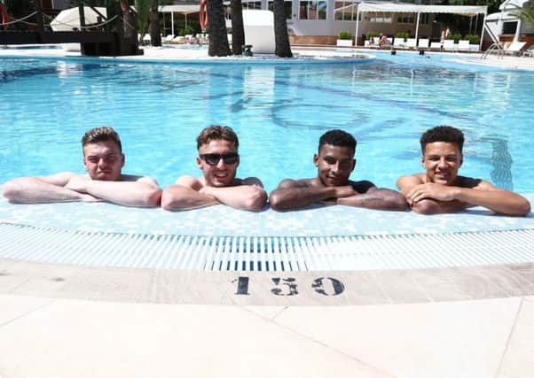 SETTLING IN IN SUNNY SPAIN - Cobblers quartet (from left) James Goff, Joe Iaciafano, Leon Lobjot and Shaun McWilliams relax in the pool at the club's Oliva Nova hotel in Spain. The players arrived on Sunday, and had some free time ahead of Monday's first training session (Picture: Pete Norton)
