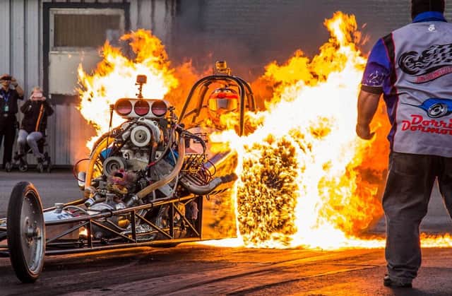 Dramatic image captures a 1,200bhp drag racing car being engulfed in flames as it performs a 'burn out' on the start line.  Photo: SWNS