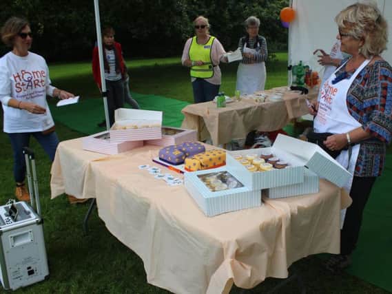 Home-Start's vice chair Hilary Bradley cuts the birthday cake as chair Jean Morgan (left) watches on.