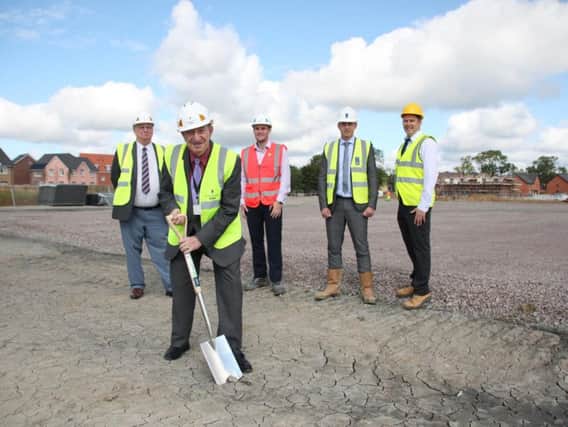 Cllr Alan Hills (front), DDCs community, culture and leisure portfolio holder, marks the start of building work with (from left) DDCs economic, regeneration and employment portfolio holder Cllr Colin Poole, Willmott Dixons building manager Tom Prince, Alex Vicary, technical executive at Crest Nicholson and Rob Saunders, surveyor project manager at DDC.