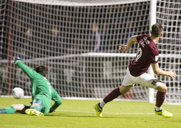 GREAT START - Chris Long slides home the Cobblers' first goal in the win over Portsmouth (Pictures: Kirsty Edmonds)